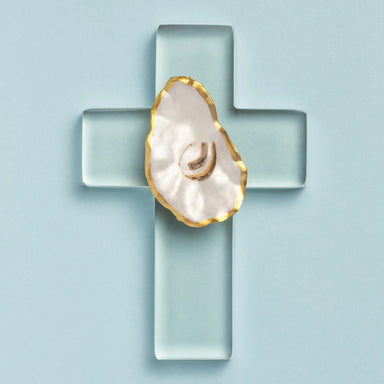 Acrylic oyster shell cross against a light blue background