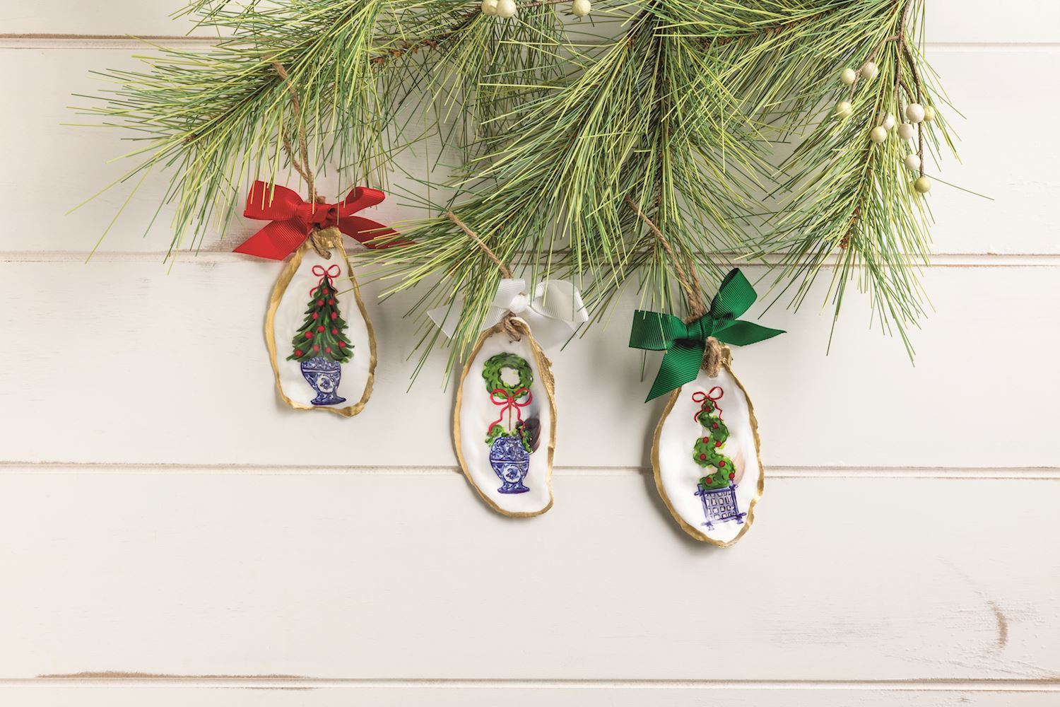 Oyster topiary ornaments on a white wood background