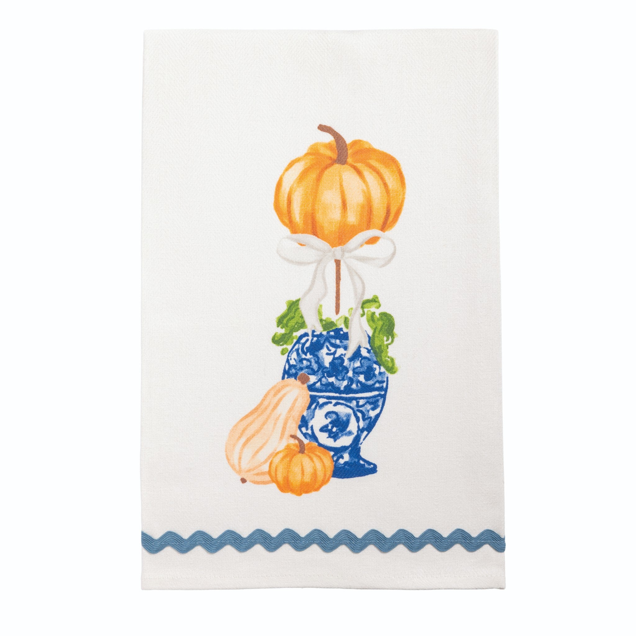 White hand towel with an orange pumpkin topiary in a blue and white pot and blue ric-rac hem