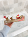 Hand holding the Santa sleigh bath toy