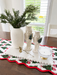 White ceramic nutcrackers on a table with greenery