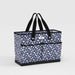 Blue floral tote bag with black handles on a light gray background