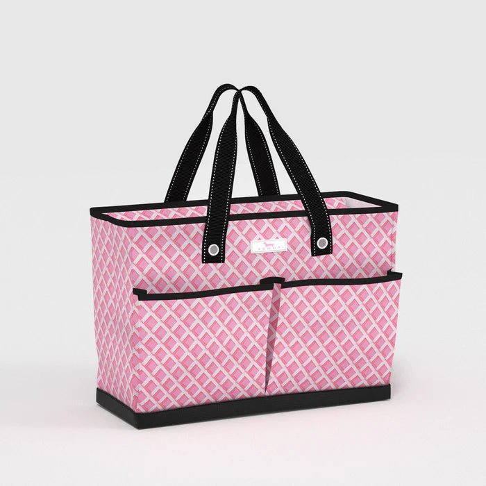 Pink patterned tote bag with black handles on a light gray background