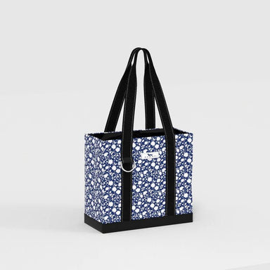 Tote bag with blue floral pattern and black handles on a light gray background