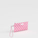 Pink and white patterned clutch with a strap on a light gray background