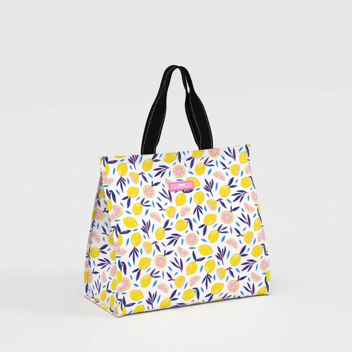 Floral patterned tote bag with black handles on a light gray background