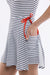 Striped dress with a red tie detail on a white background - close up view