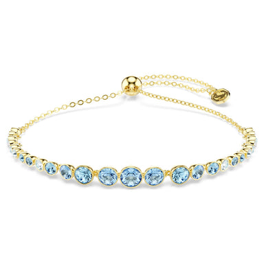 Gold Imber bracelet with gradient blue crystals on a white background
