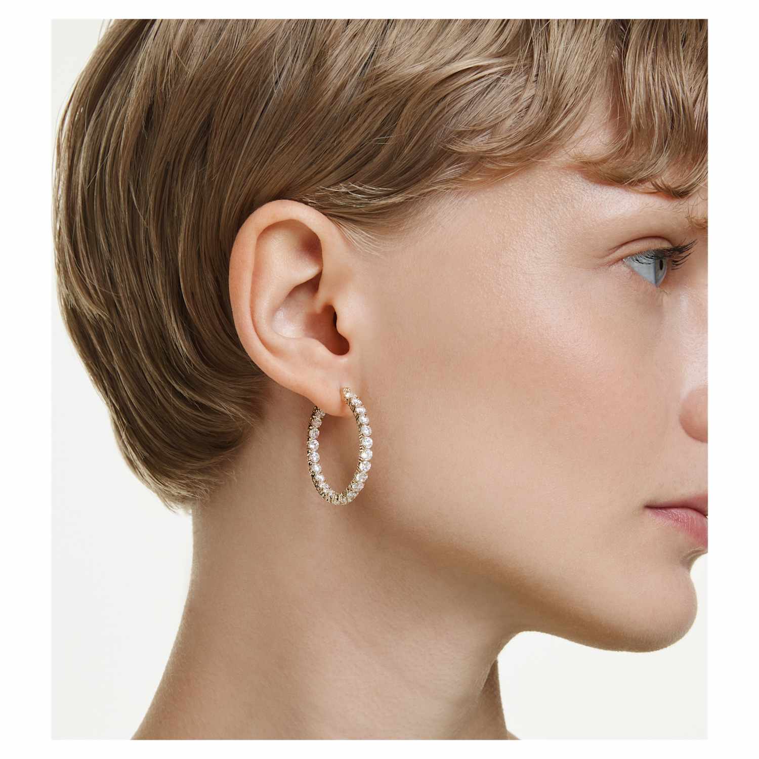 Model wearing the gold Matrix crystal hoop earrings