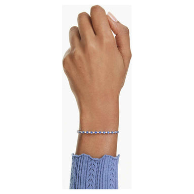 Model wearing the silver Matrix tennis bracelet with deep blue and clear stones