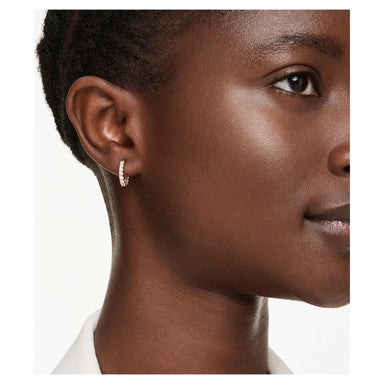 Model wearing the gold Matrix Vittore mini hoop earrings