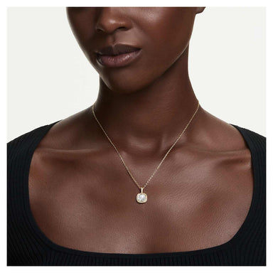 Model wearing the gold Una Angelic cushion-cut crystal pendant