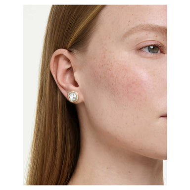 Model wearing the gold Una Angelic cushion-cut crystal stud earrings