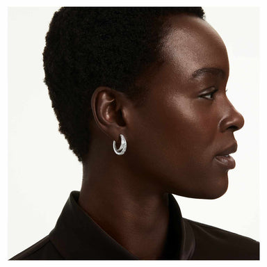 Model wearing the silver Vienna feather-shaped hoop earrings