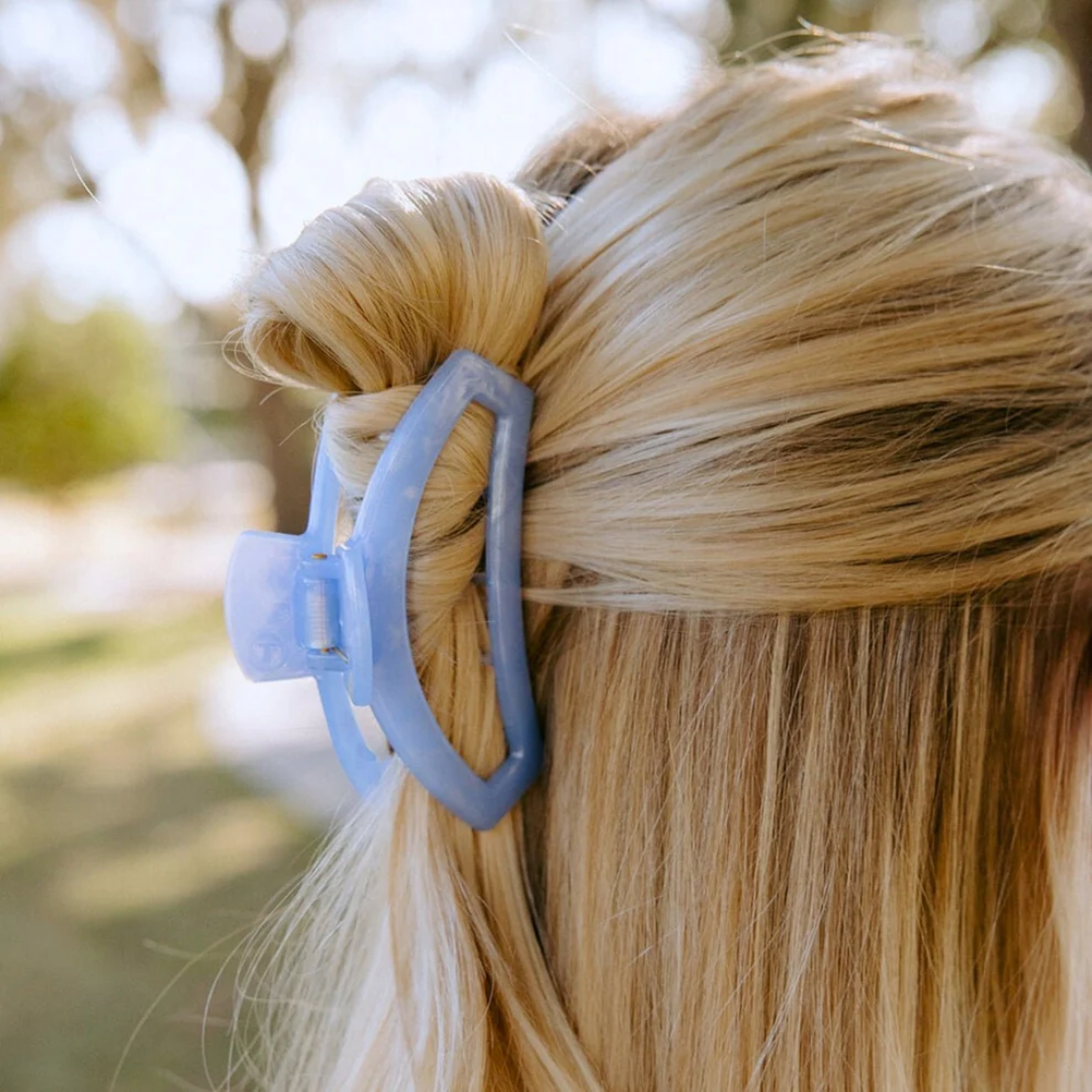 blue hair clip in blonde models hair 