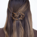 tortoise colored hair clip in models hair against white background