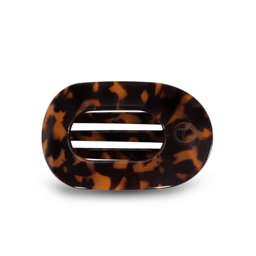 tortoise colored hair clip against white background