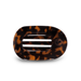 tortoise colored hair clip against white background