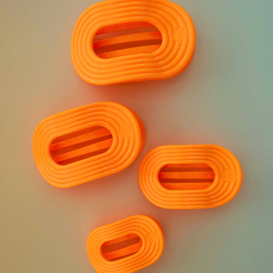 orange hairclips on neutral background